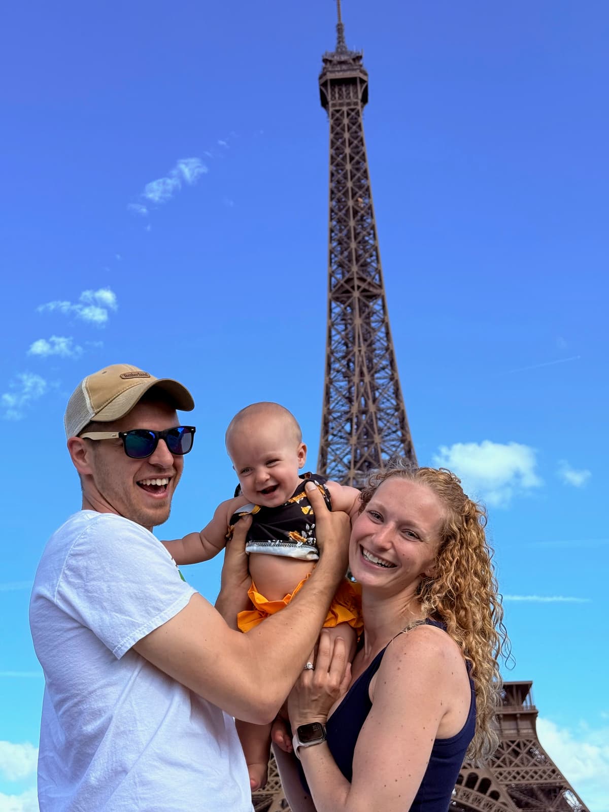 Caitlyn Diadiun, Founder of Trinity Marketing & Media, with her family in front of the Eiffel Tower